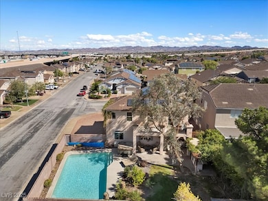 Aerial view of residential area with a pool area and mountains