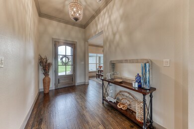 Tall ceiling in entry with hand scraped hardwoods and upgraded lighting. 48