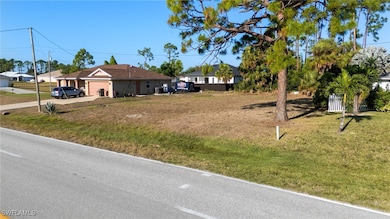 View of yard with a garage and concrete driveway