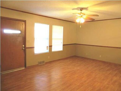 Large, open living space with neutral colors and b