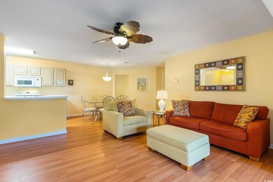 Living area featuring light wood-type flooring, a ceiling fan, and baseboards