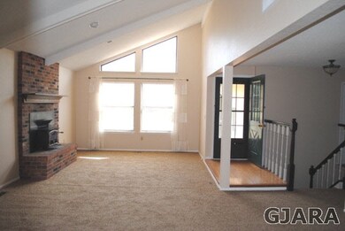 bright and airy living room with vaulted ceiling a