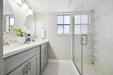 Updated bathroom featuring spacious glass-enclosed