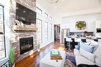 Living room with a fireplace, light hardwood / woo