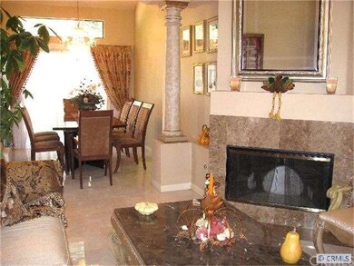 A lovely marble fireplace graces the formal living