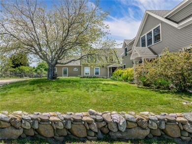 A beautiful stone wall flanks the property where t