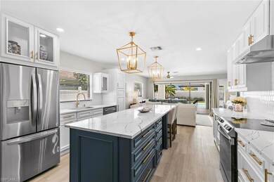 Kitchen featuring open floor plan, appliances with