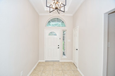 Bright entryway with a white front door featuring