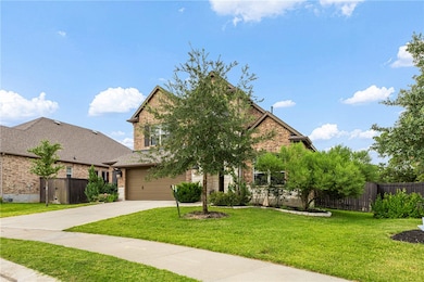 View of front of house featuring brick siding, a garage, and concrete driveway