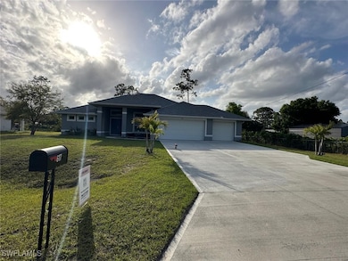 Ranch-style house featuring driveway, an attached
