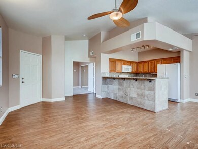 View from living room into the kitchen and front b