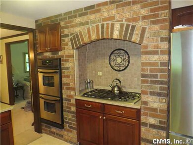 Kitchen. Gas cook range surrounded by beautiful br