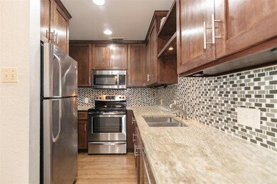 Kitchen featuring stainless steel appliances, bac