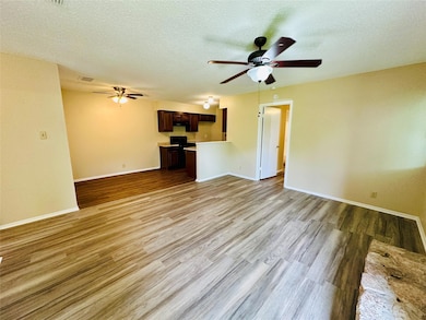 Unfurnished living room with ceiling fan, light w