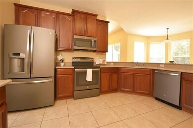 The kitchen boasts maple cabinets with 42
