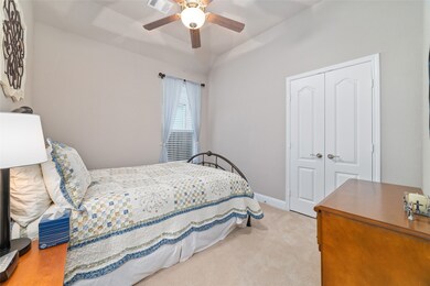 The first of two secondary bedrooms features upgraded carpeting and plenty of storage space. Both secondary bedrooms easily fit queen beds and accent furnishings.