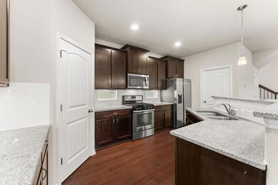 Kitchen with stainless steel appliances, a sink, 