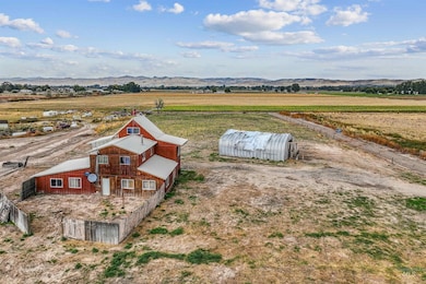 View of rural area with a mountainous background and rows of crops