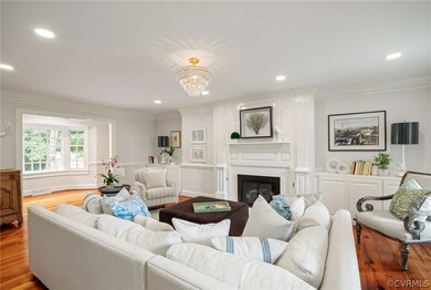 Living room with crown molding, gas fireplace with