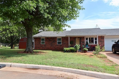 Ranch-style home with a garage, a front yard, a porch, roof with shingles, and brick siding