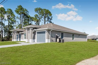 View of front facade featuring a front yard, a gar