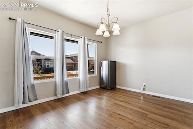 Unfurnished room with a chandelier, wood finished 