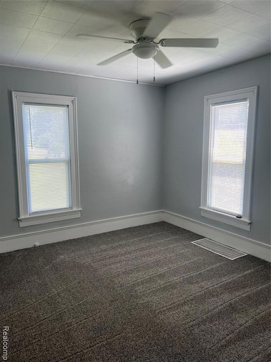 Living room with new windows, blinds and carpet.