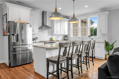 Open and bright kitchen with granite countertops.