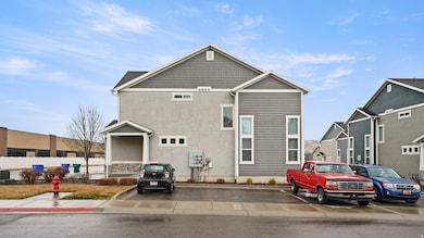 View of front facade with uncovered parking and stucco siding