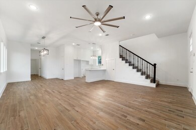 Find storage space underneath the iron-rod spindle staircase and additional seating at your kitchen peninsula.