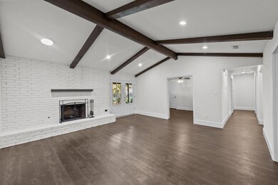 Unfurnished living room with ceiling fan, a firepl