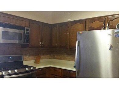 Kitchen cabinets with microwave shown