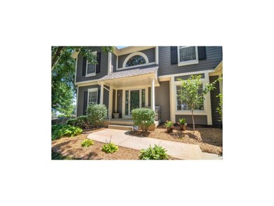 Covered porch surrounded by lovely landscaping!