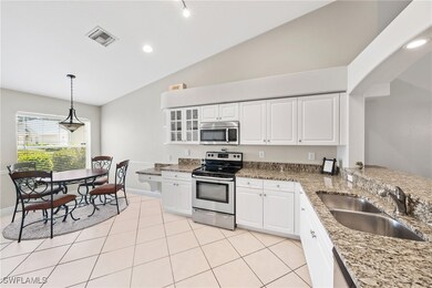 Kitchen with stainless steel appliances, white cab