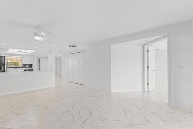 Unfurnished living room with a skylight, sink, lig