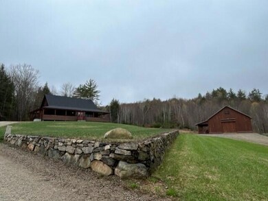Front with rockwall and barn