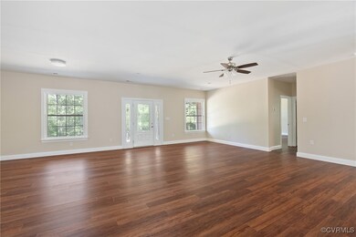 Empty room featuring dark wood-type flooring and ceiling fan