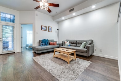 Living room featuring a high ceiling, dark hardwoo