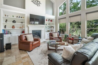 Living room with built in shelves, a high ceiling