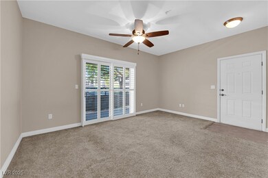 Empty room with a ceiling fan and carpet
