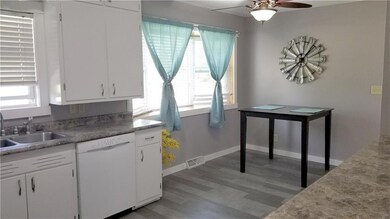 View from kitchen into main hallway and front entr