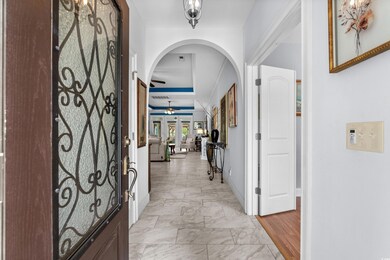Foyer featuring a ceiling fan, visible vents, base