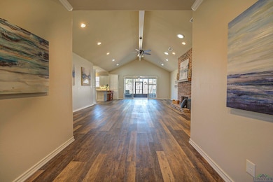 Unfurnished living room with beamed ceiling, baseb