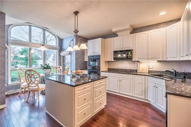 Kitchen with granite countertops and hardwood floo