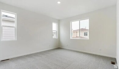 Spare room with light carpet and recessed lighting