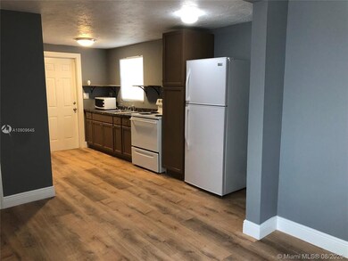 From the living area looking back towards the kitchen and entrance.