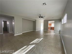 Unfurnished living room featuring baseboards and c
