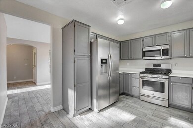 Sunny kitchen with garden window, stainless steel