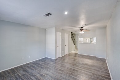 Spare room featuring ceiling fan, wood finished floors, stairs, and recessed lighting
