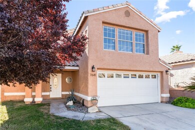 View of front facade with stucco siding, driveway, a tiled roof, and an attached garage